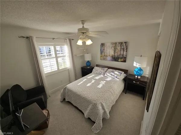 a bedroom with a bed dresser and a window