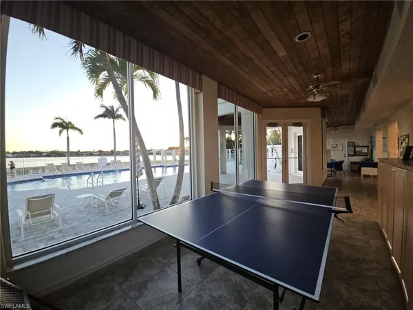 a view of a livingroom with furniture and floor to ceiling window