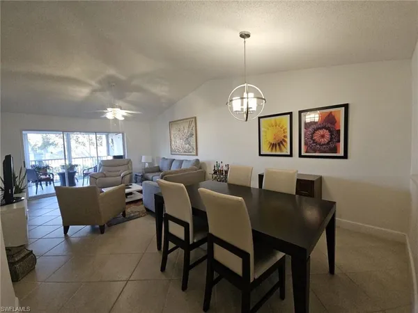 a view of a dining room with furniture and a chandelier
