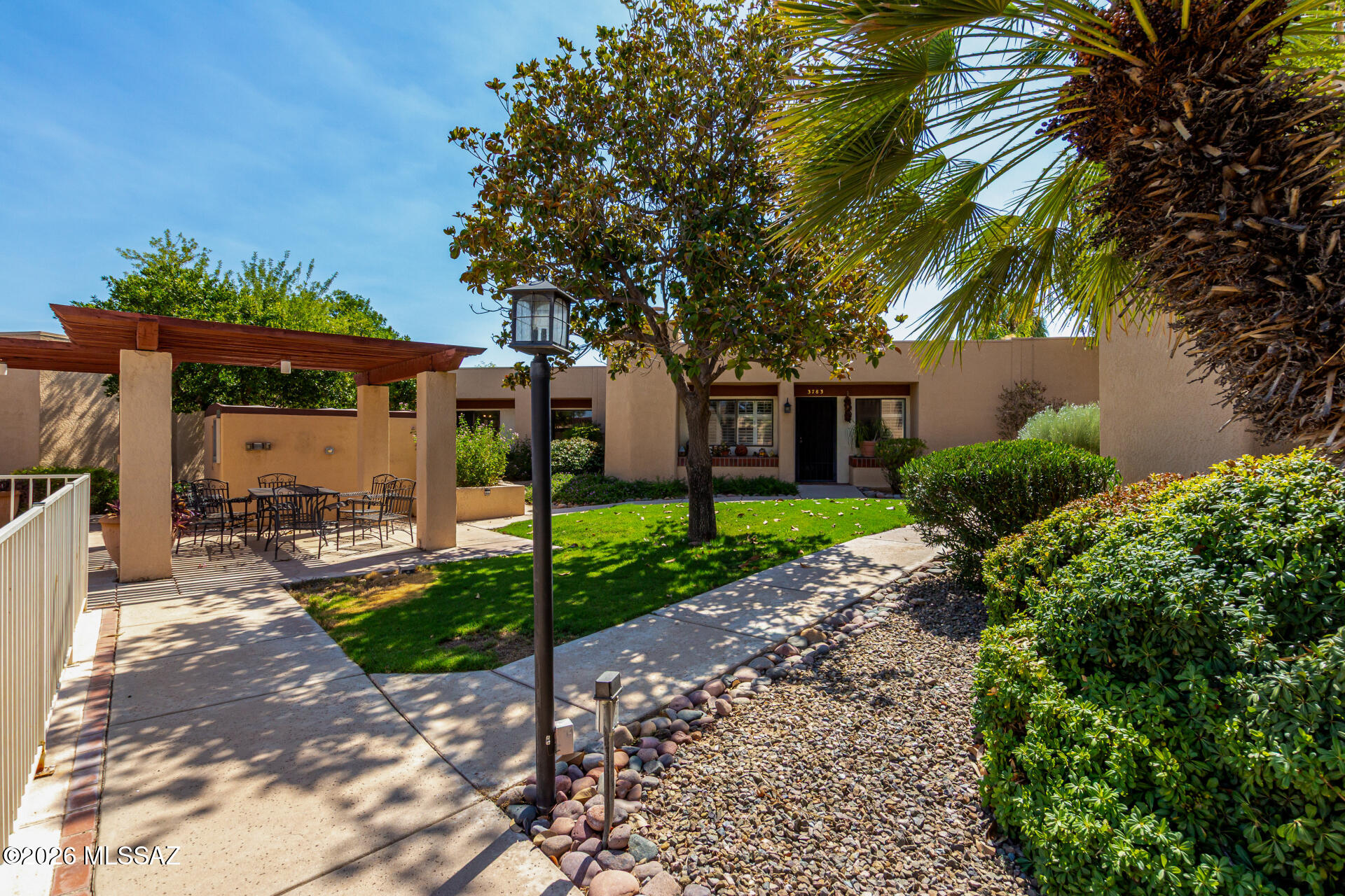 3781 East Edison Street Tucson, AZ 85716 - Photo 26 of 28 a view of a house with a small yard and palm trees