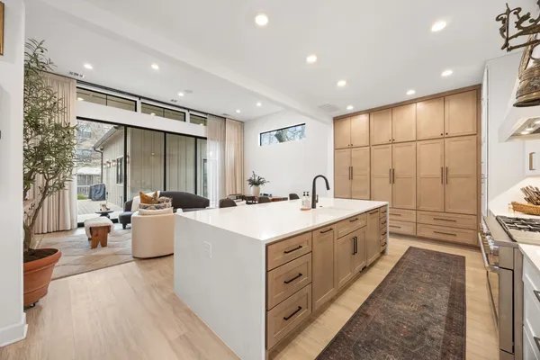 a large white kitchen with a large window