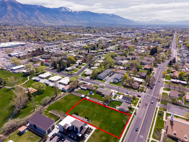 830 North 200 West Logan, UT 84321 - Photo 2 of 7 Aerial view of residential area featuring property parcel outlined and mountains