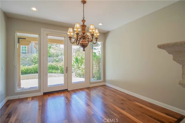 a kitchen with stainless steel appliances granite countertop a sink a stove and a granite counter tops with wooden floor