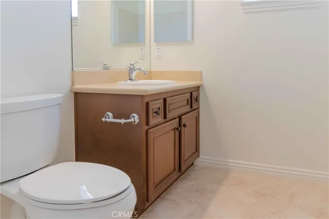 a bathroom with a granite countertop double vanity sink and a mirror