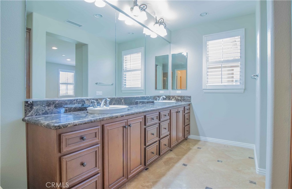 4684 Luna Court Calabasas, CA 91302 - Photo 29 of 48 a bathroom with a granite countertop double vanity sink and a mirror