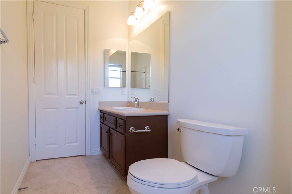 4684 Luna Court Calabasas, CA 91302 - Photo 37 of 48 a bathroom with a sink a toilet and vanity