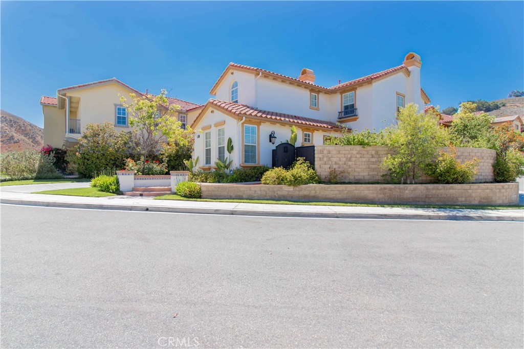 4684 Luna Court Calabasas, CA 91302 - Photo 4 of 48 a front view of a house with a yard and large trees