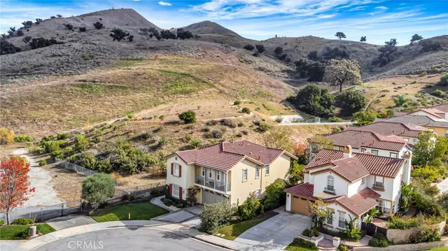 an aerial view of a house with a swimming pool and outdoor seating
