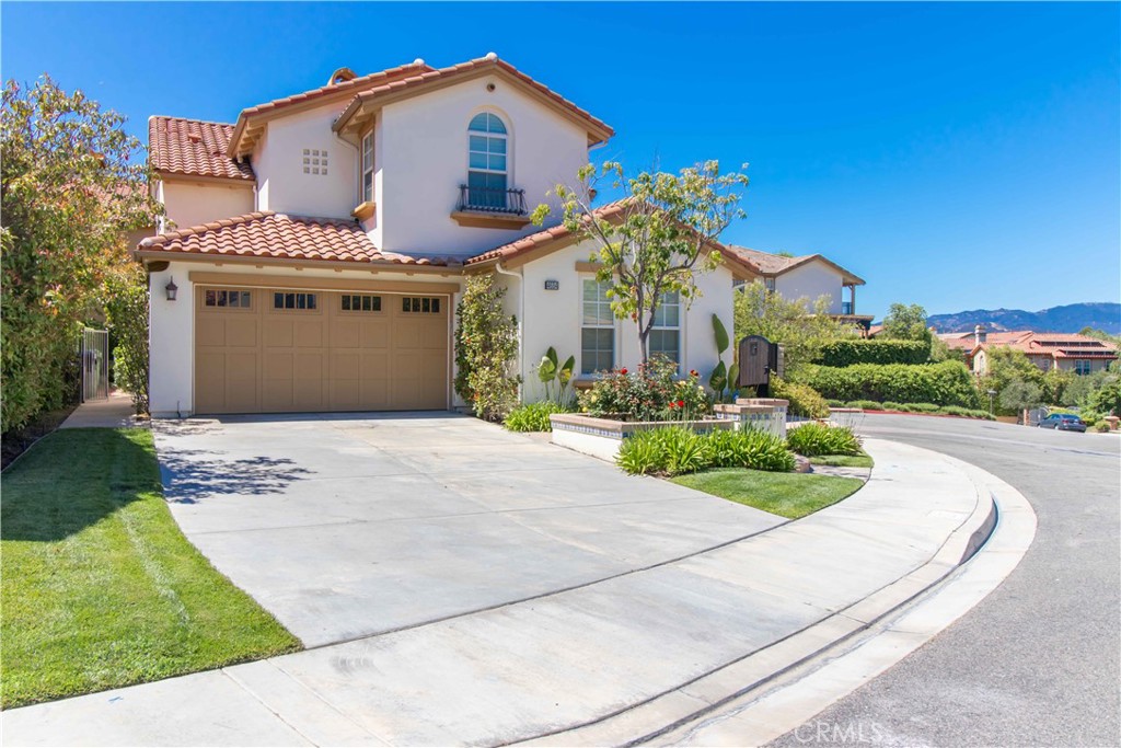 4684 Luna Court Calabasas, CA 91302 - Photo 5 of 48 a front view of a house with a garden and plants