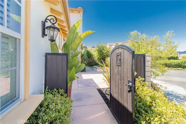 a front view of a house with a yard and fountain