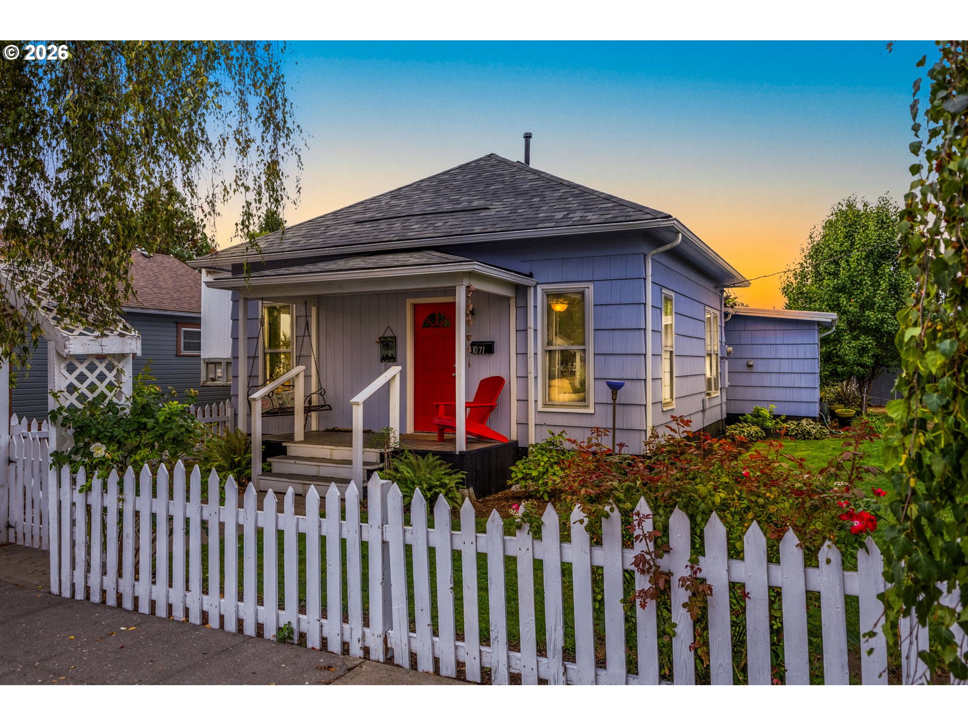 a front view of house with wooden fence