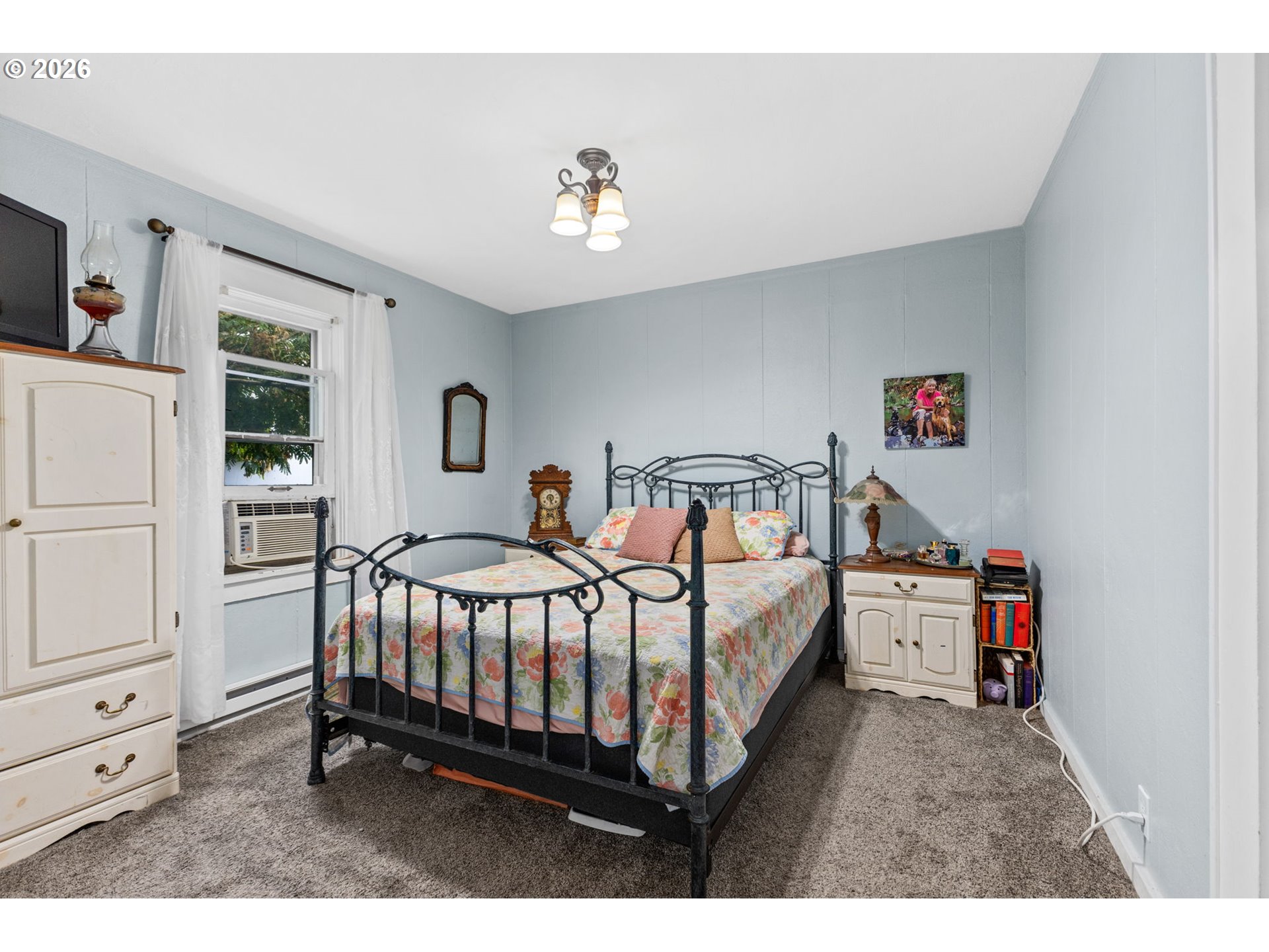 1071 Southwest Church Street Dallas, OR 97338 - Photo 12 of 27 a bedroom with a bed and a chandelier