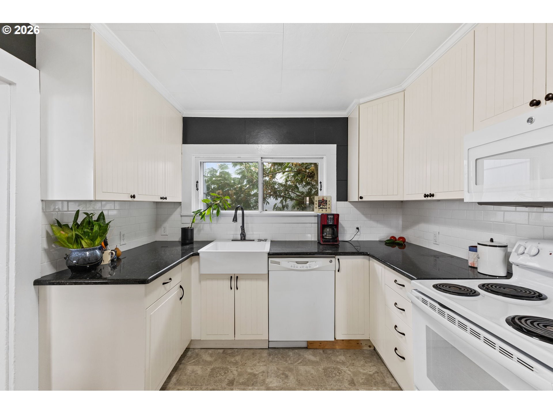 1071 Southwest Church Street Dallas, OR 97338 - Photo 9 of 27 a kitchen with a sink stove and white cabinets