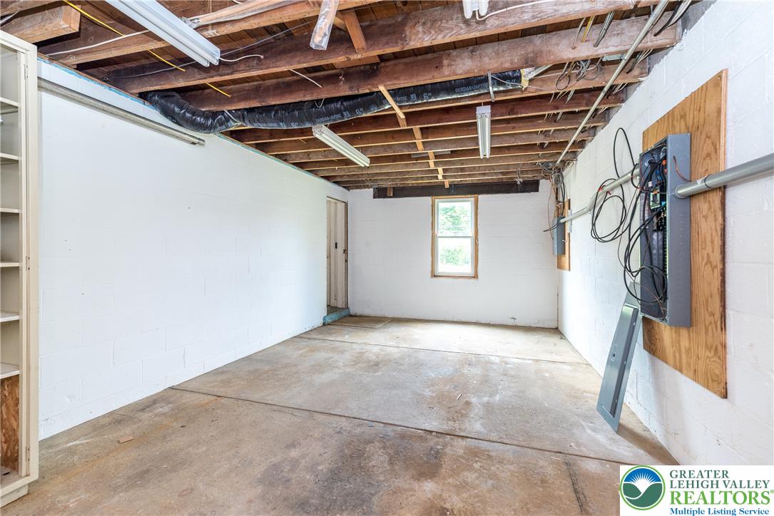 1815 Leithsville Road Hellertown, PA 18055 - Photo 25 of 38 A utilitarian basement space offers storage potential and access to utilities.