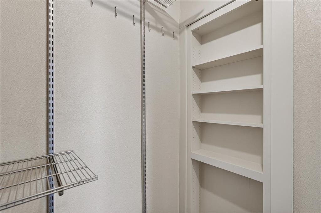 2828 Bennett Road Howe, TX 75459 - Photo 23 of 39 a view of walk in closet with empty racks