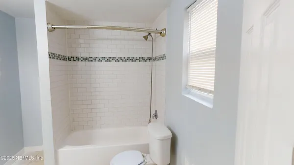 a bathroom with a shower and a bathtub