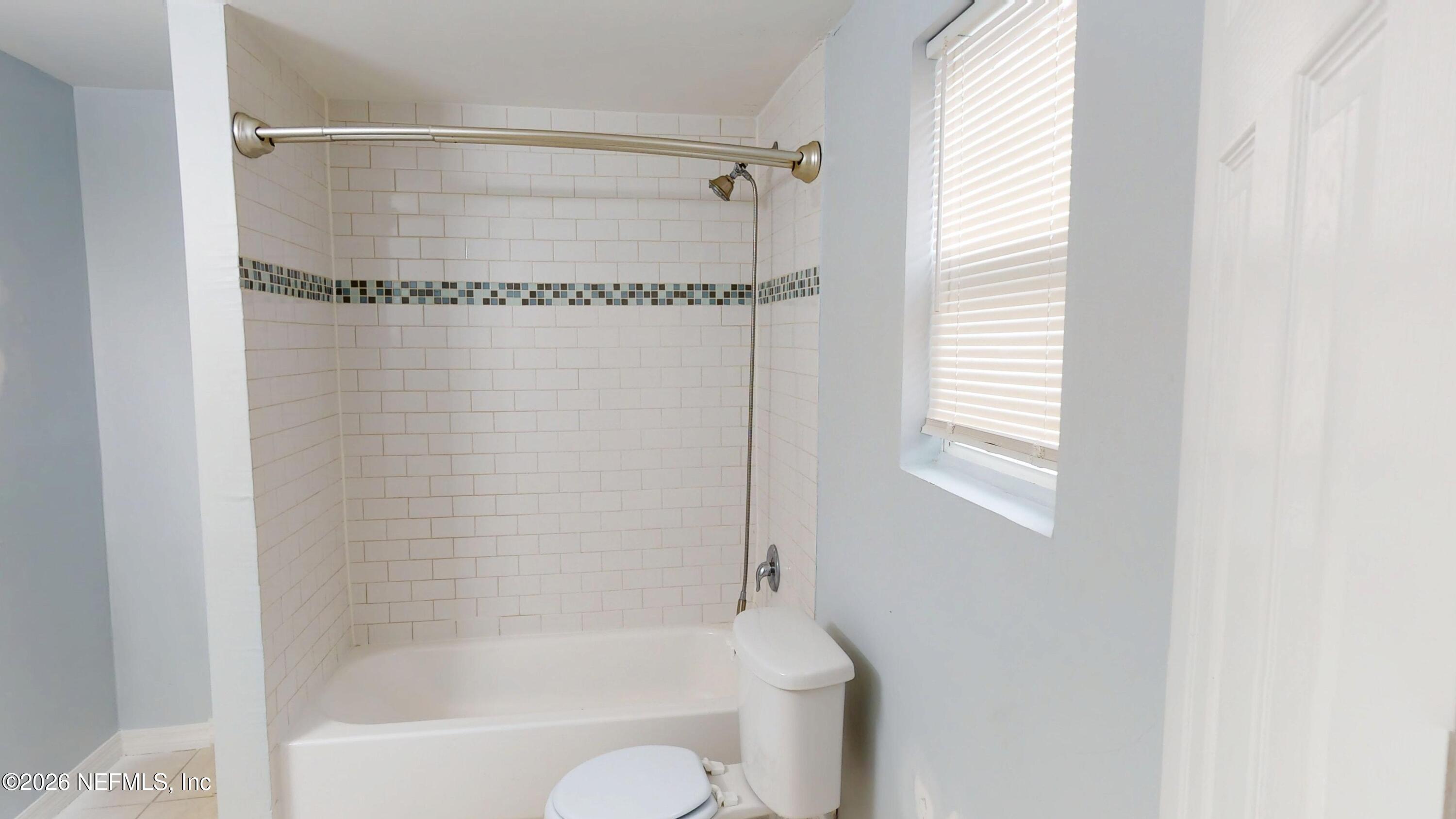 6926 Camelot Road Jacksonville, FL 32211 - Photo 11 of 16 a bathroom with a shower and a bathtub