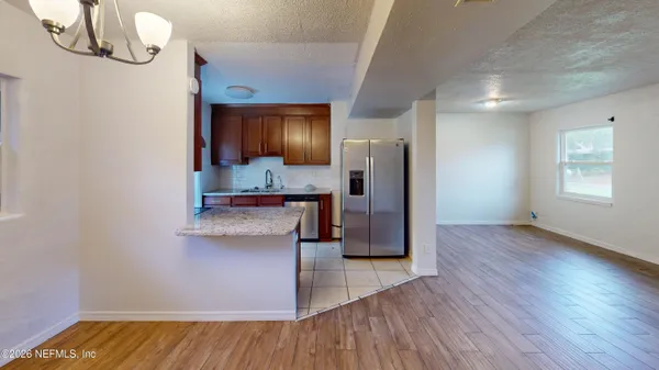 a kitchen with a refrigerator and a stove top oven