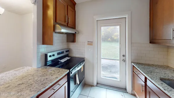 a kitchen with stainless steel appliances granite countertop a stove and a refrigerator