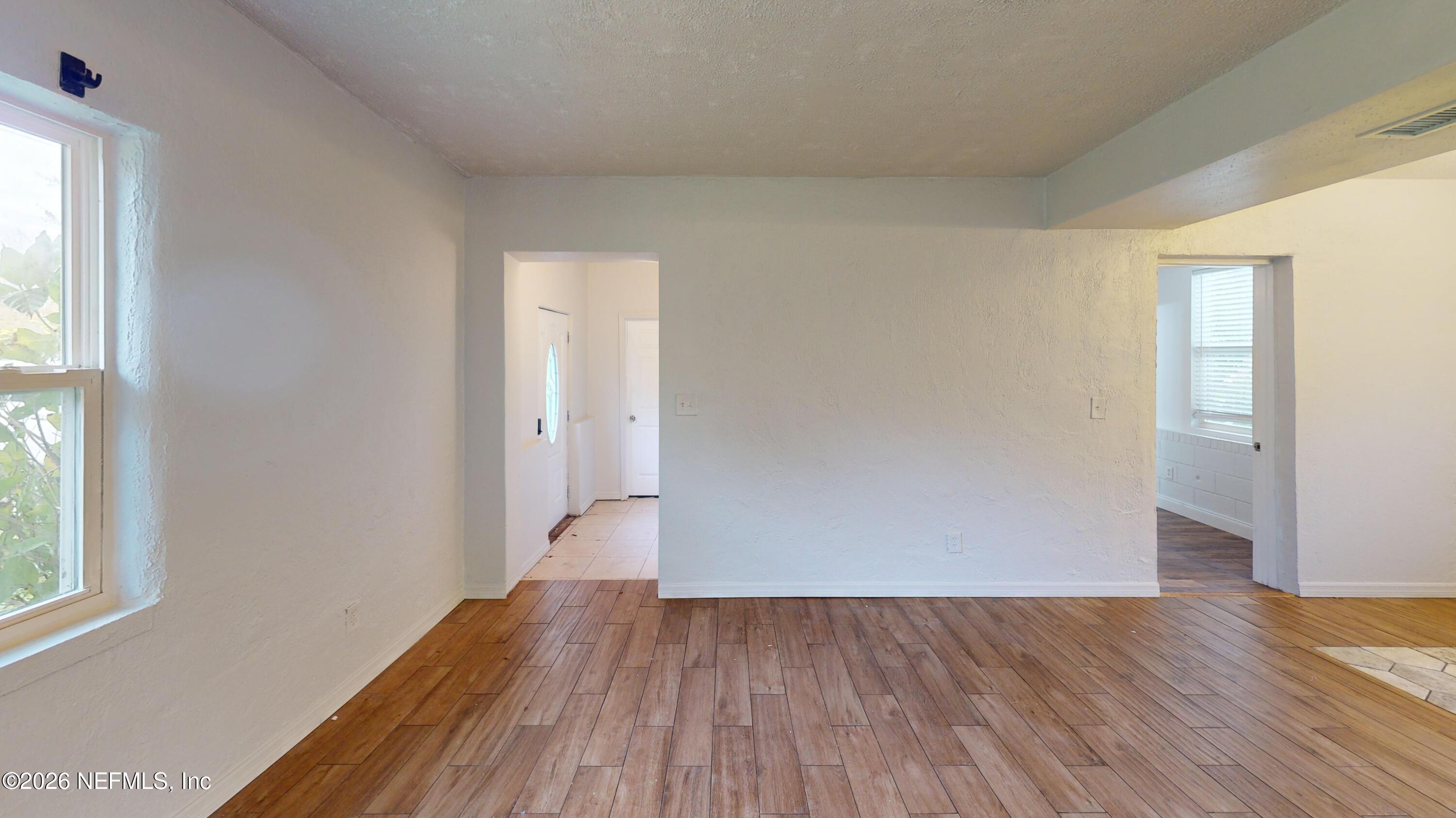 6926 Camelot Road Jacksonville, FL 32211 - Photo 5 of 16 an empty room with wooden floor and windows