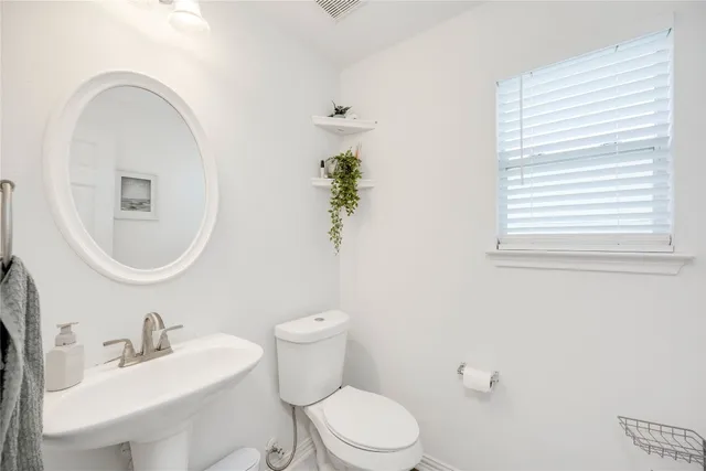 a spacious bedroom with a large bed and a chandelier