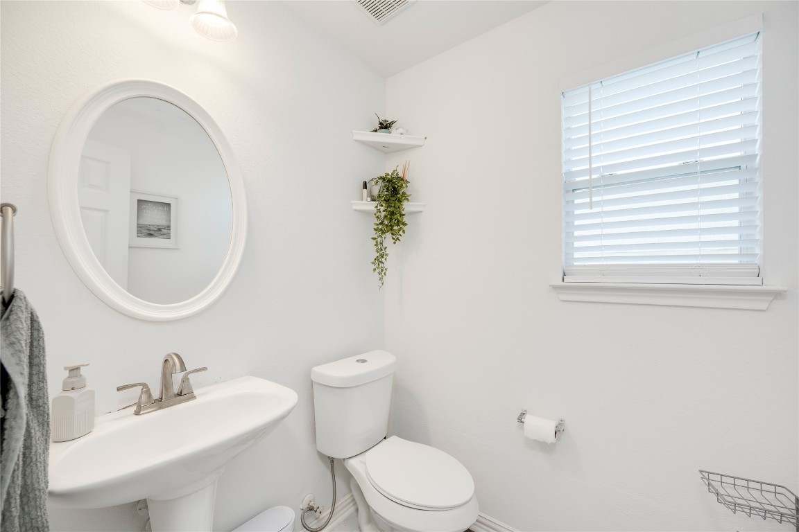 148 Buttercup Way Kyle, TX 78640 - Photo 16 of 40 a white toilet sitting next to a bathroom sink