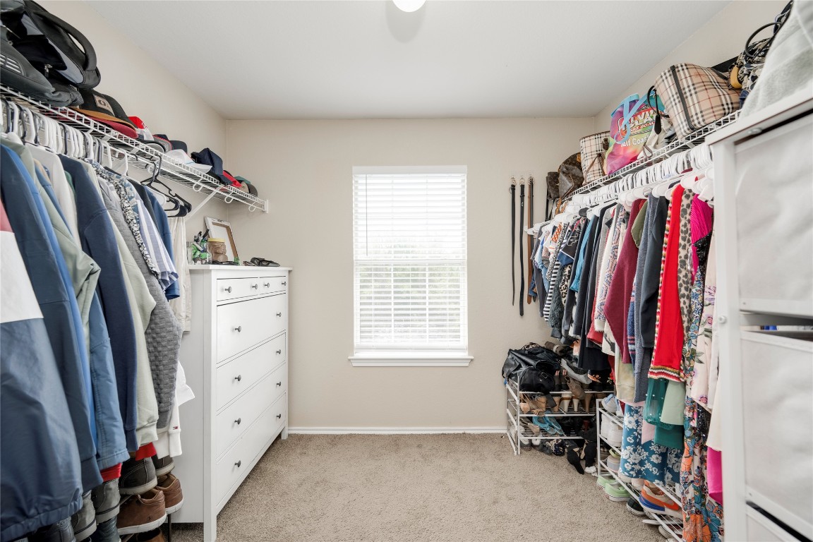 148 Buttercup Way Kyle, TX 78640 - Photo 20 of 40 a view of walk in closet with clothes