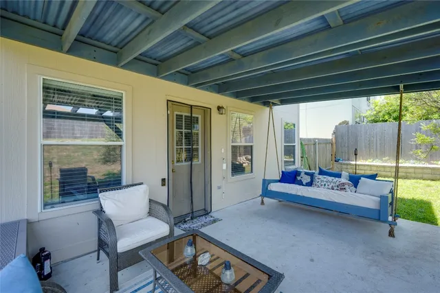 a view of a house with backyard and sitting area