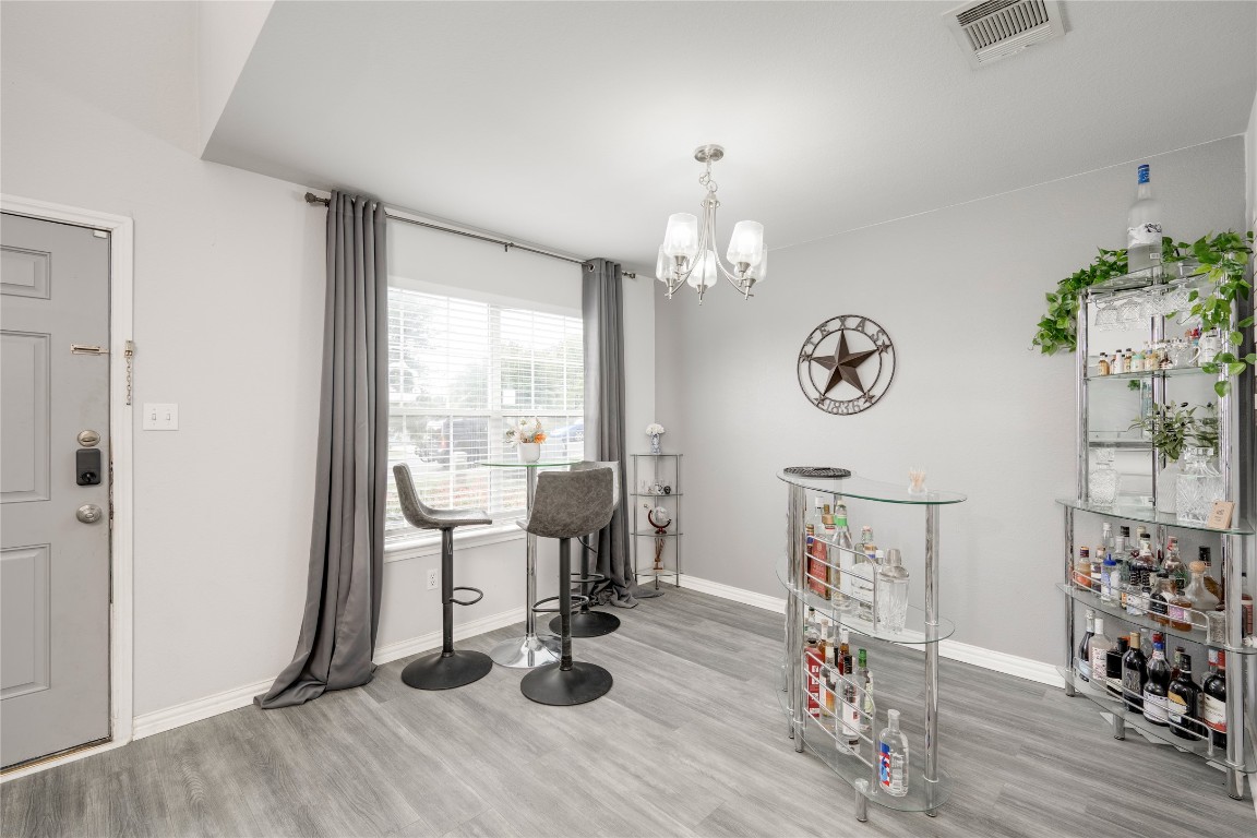148 Buttercup Way Kyle, TX 78640 - Photo 6 of 40 a view of a room with wooden floor and windows
