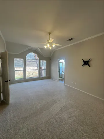 an empty room with windows and fireplace