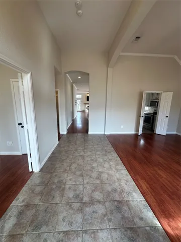 a view of a hallway view with wooden floor and seating space