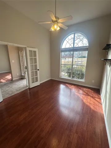 wooden floor in an empty room with a window