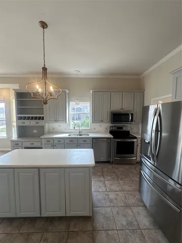 a modern kitchen with stainless steel appliances granite countertop a stove a sink and a refrigerator