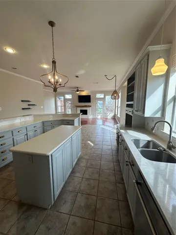 a large kitchen with stainless steel appliances lots of counter space sink and cabinets