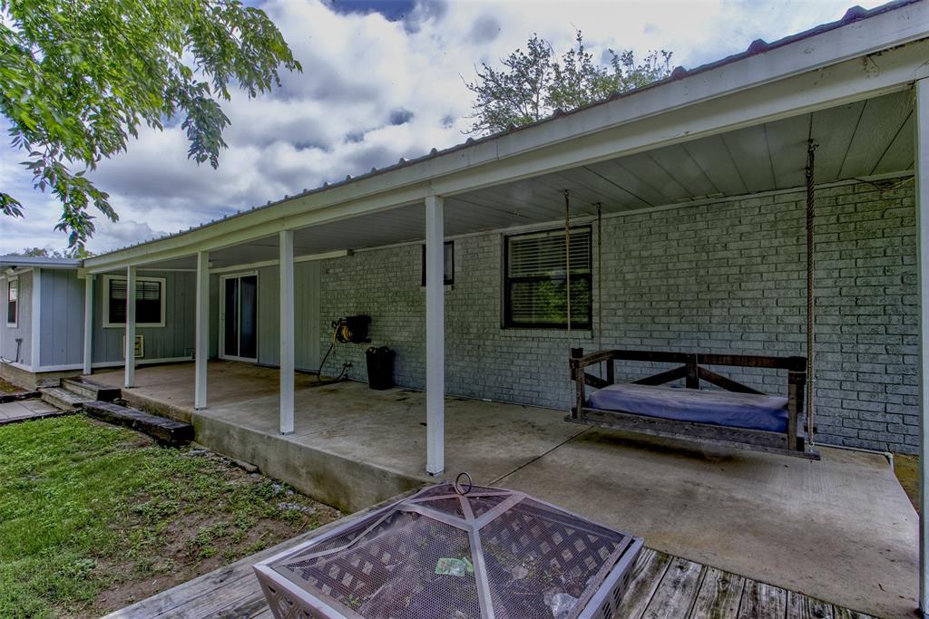 209 Case Street Weatherford, TX 76086 - Photo 22 of 25 Covered back porch with porch swing that stays