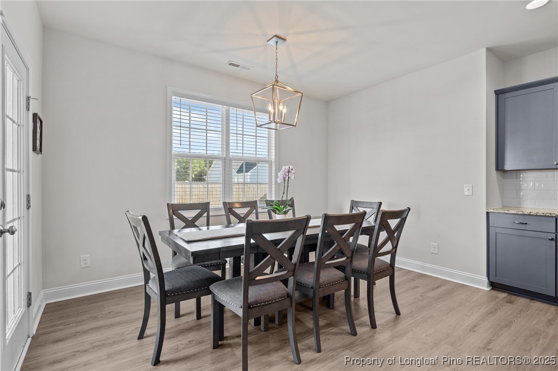 212 Winnsboro Road Raeford, NC 28376 - Photo 16 of 50 a view of a dining room with furniture window and wooden floor