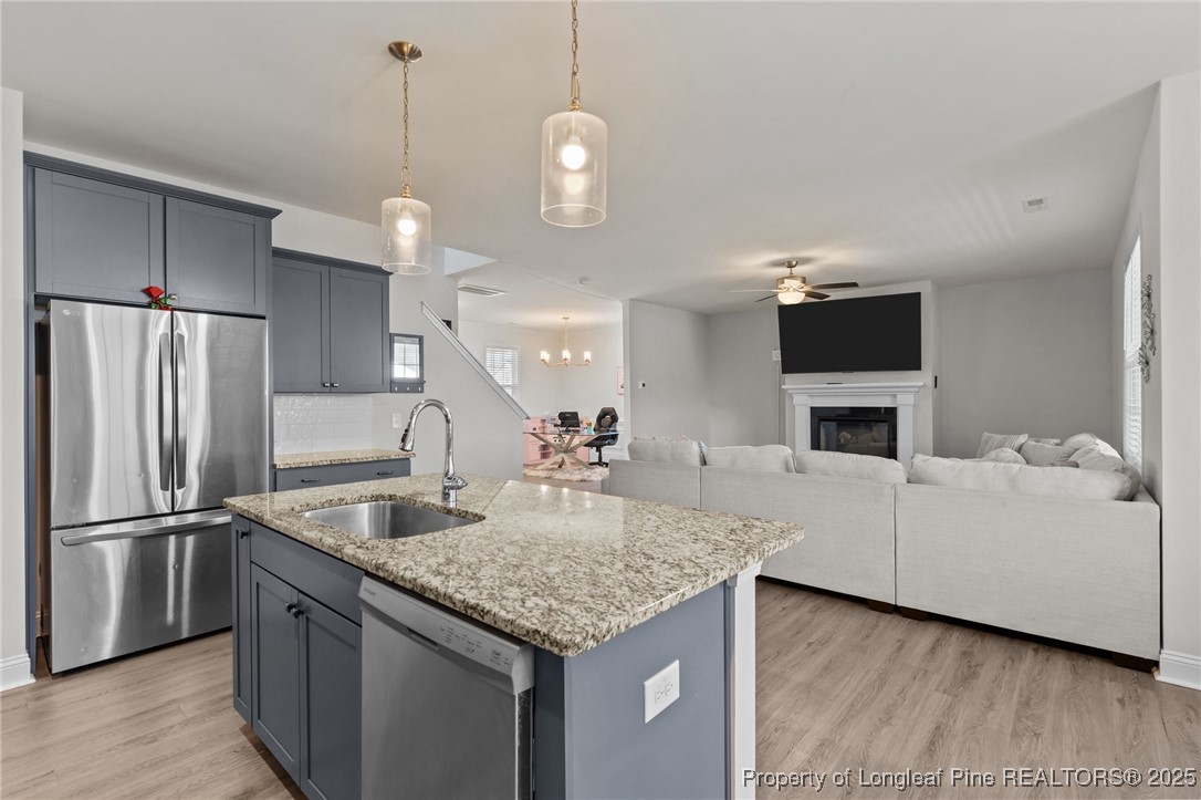 212 Winnsboro Road Raeford, NC 28376 - Photo 20 of 50 a kitchen with kitchen island a counter top space stainless steel appliances and a chandelier