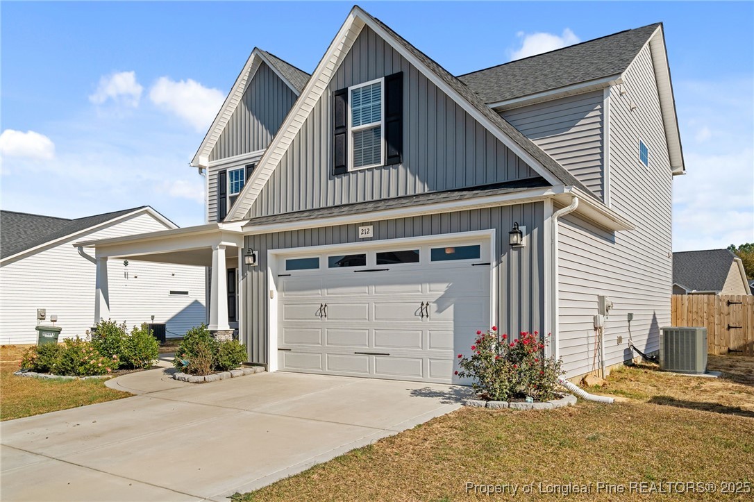 212 Winnsboro Road Raeford, NC 28376 - Photo 2 of 50 a front view of a house with a yard and garage