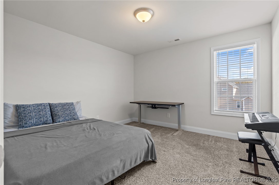 212 Winnsboro Road Raeford, NC 28376 - Photo 32 of 50 a bedroom with a bed and a desk