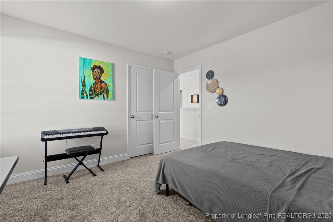 212 Winnsboro Road Raeford, NC 28376 - Photo 33 of 50 a bedroom with a bed and painting on the wall