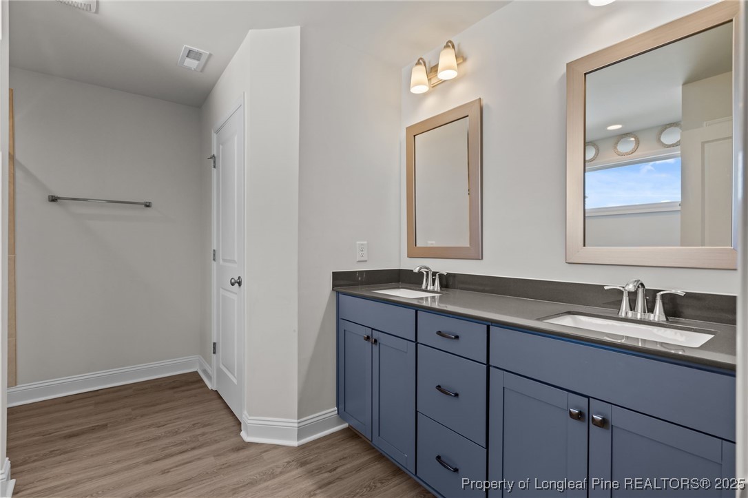 212 Winnsboro Road Raeford, NC 28376 - Photo 34 of 50 a bathroom with a double vanity sink and a mirror