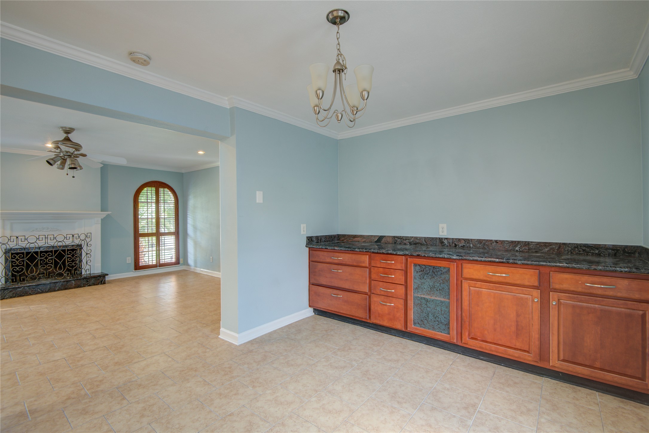 1424 Silverpines Road, Unit 1424 Houston, TX 77062 - Photo 11 of 33 a view of an empty room with chandelier fan and a fireplace