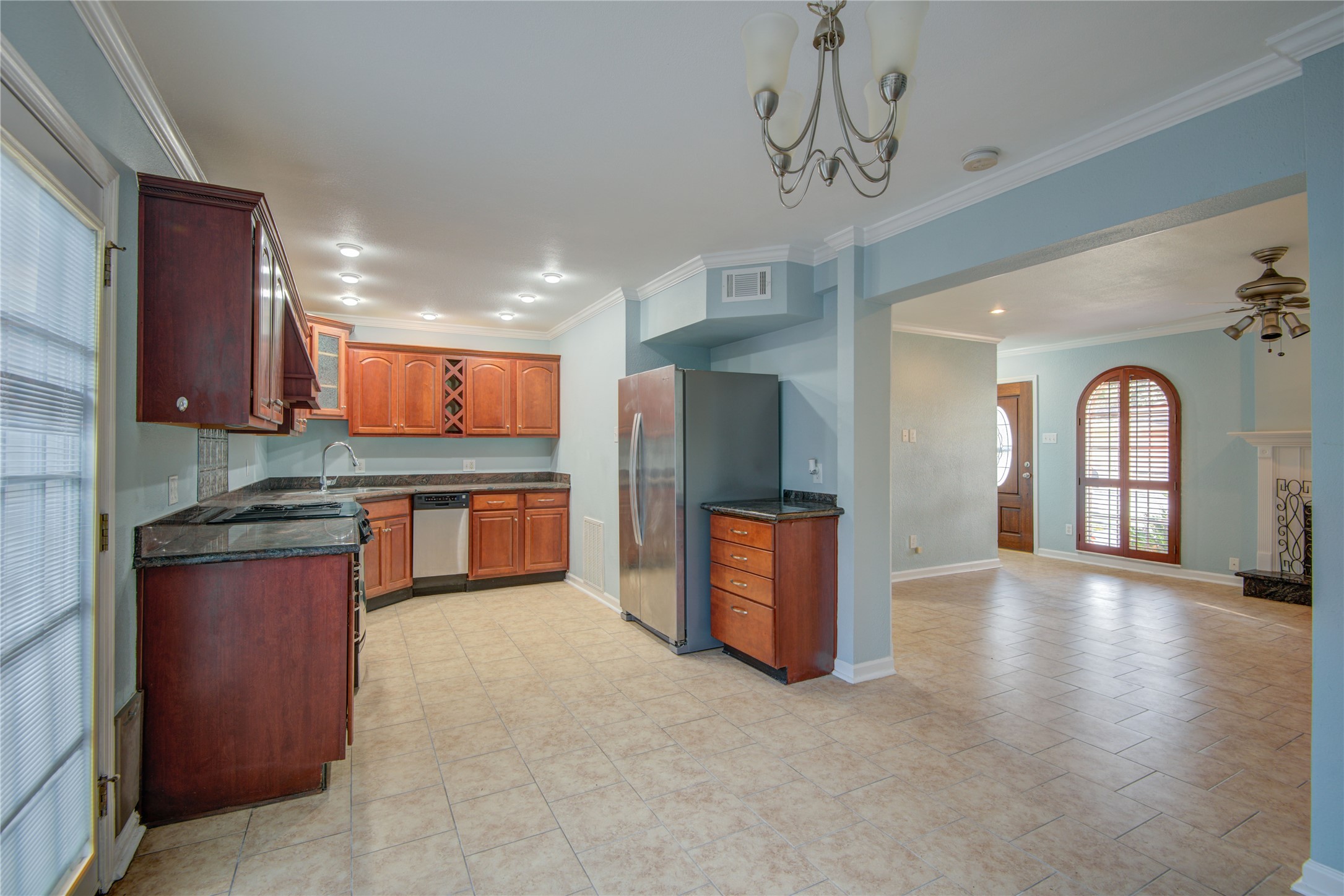 1424 Silverpines Road, Unit 1424 Houston, TX 77062 - Photo 12 of 33 a large kitchen with stainless steel appliances granite countertop a refrigerator a sink dishwasher a stove and a dining table with wooden floor