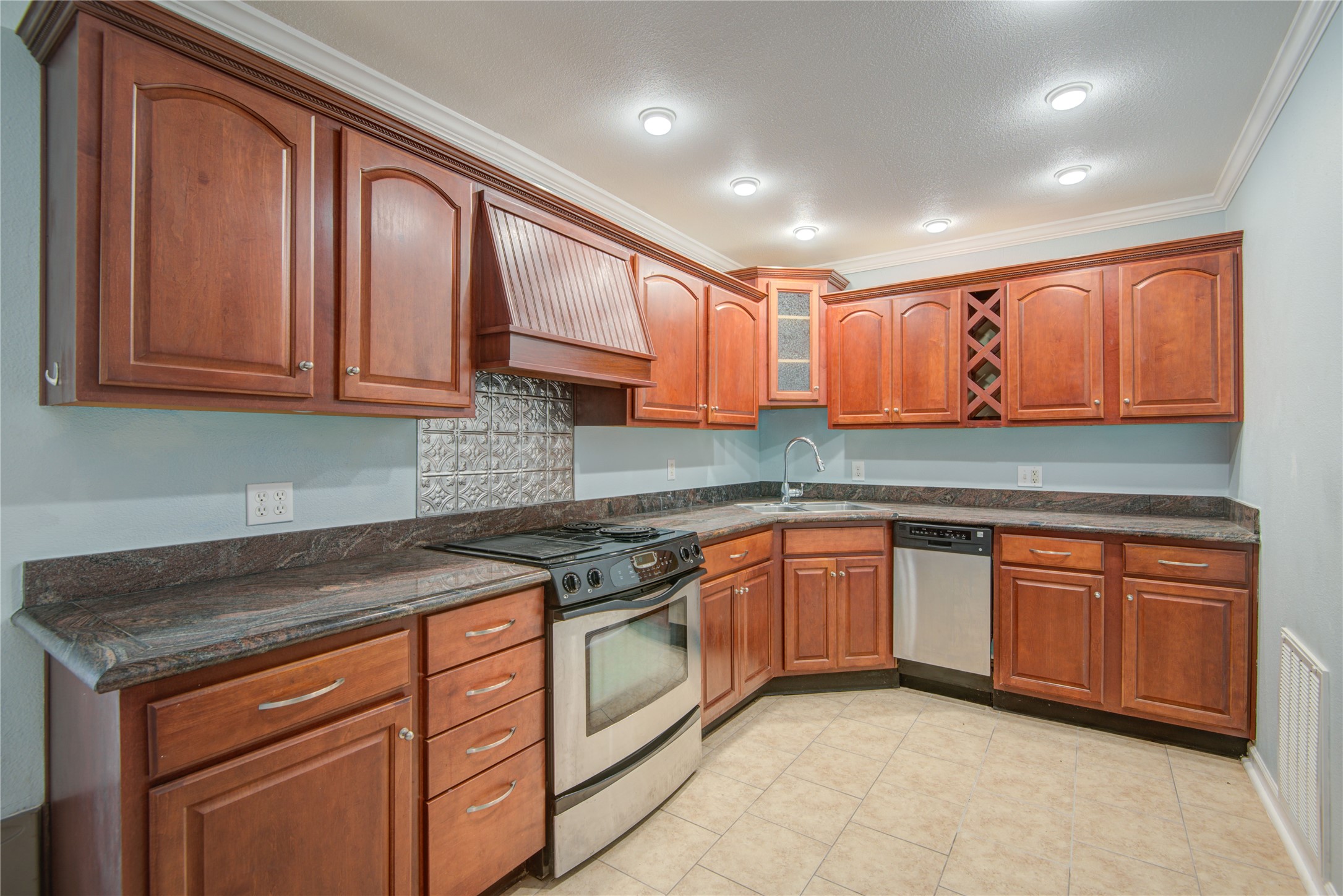 1424 Silverpines Road, Unit 1424 Houston, TX 77062 - Photo 13 of 33 a kitchen with stainless steel appliances granite countertop wooden cabinets a sink and dishwasher