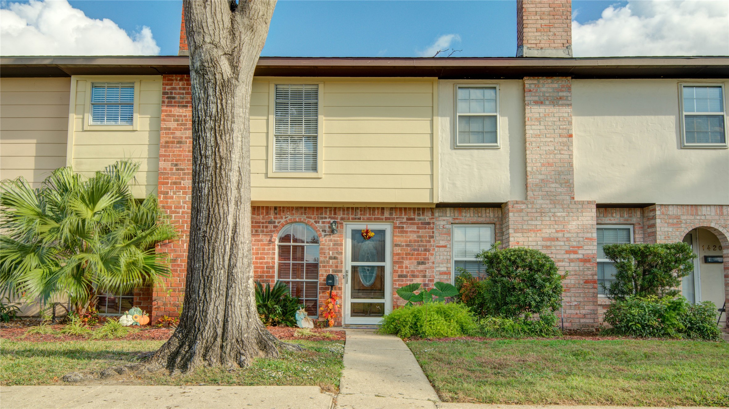 1424 Silverpines Road, Unit 1424 Houston, TX 77062 - Photo 5 of 33 a front view of a house with a yard