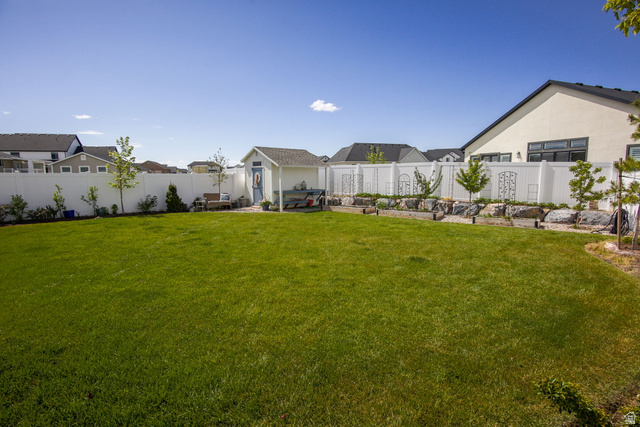 910 South 1700 West Layton, UT 84041 - Photo 24 of 26 Fenced backyard with a residential view and an outbuilding