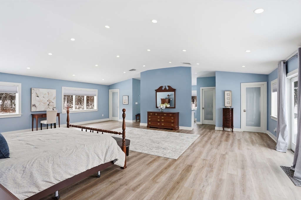 235 Kemp Street Dunstable, MA 01827 - Photo 16 of 42 a spacious bedroom with a large bed and a flat screen tv