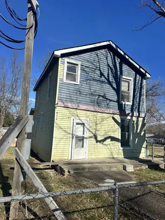 a view of a house with a tree