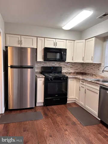 a kitchen with a refrigerator stove and microwave