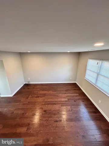 a view of wooden floor and windows in a room